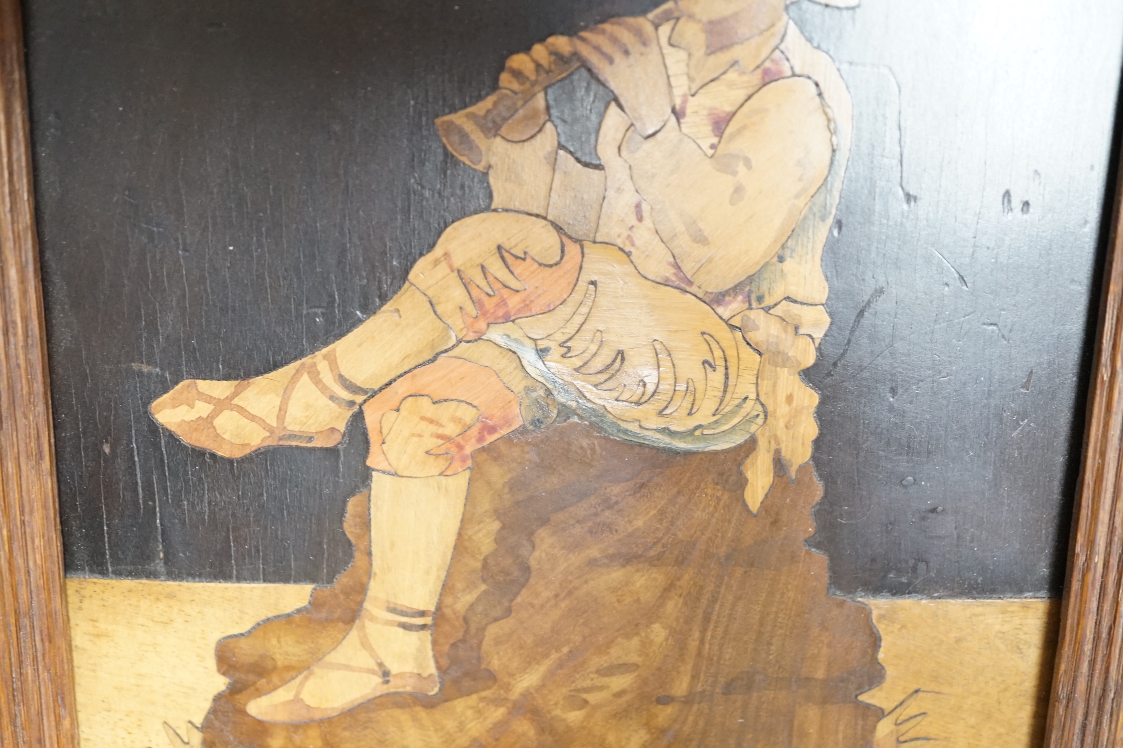 A Sorrentoware marquetry panel of a boy playing a flute, 14cm wide, 21.5cm high